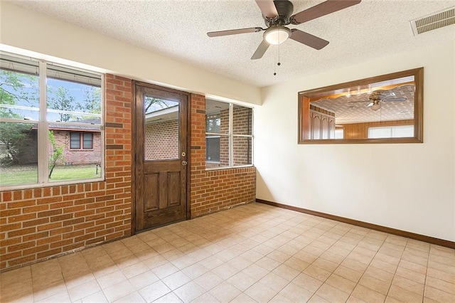 47116 N Morrison Blvd, Hammond, LA 70401 - interior space with a ceiling fan, brick wall, a textured ceiling, visible vents, and baseboards