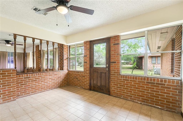 47116 N Morrison Blvd, Hammond, LA 70401 - tiled foyer featuring a textured ceiling, brick wall, visible vents, and ceiling fan