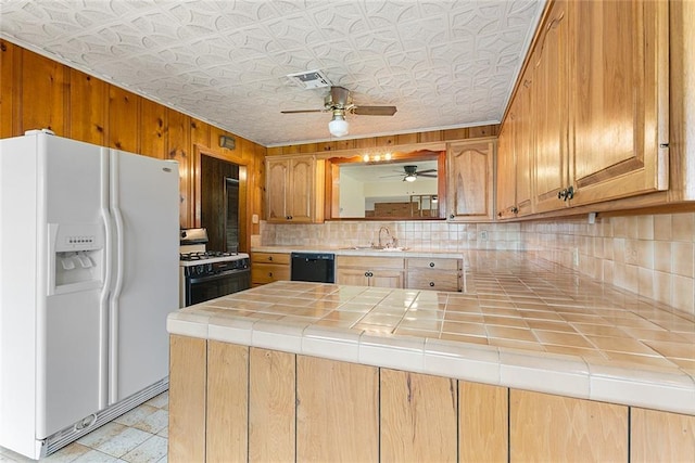 47116 N Morrison Blvd, Hammond, LA 70401 - kitchen with ceiling fan, black dishwasher, range with gas cooktop, a sink, and white fridge with ice dispenser