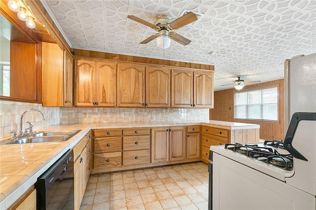 47116 N Morrison Blvd, Hammond, LA 70401 - kitchen featuring white gas range, ceiling fan, dishwasher, a sink, and tile counters