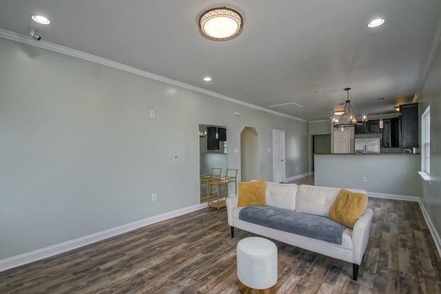 living area with baseboards, ornamental molding, recessed lighting, arched walkways, and dark wood-style floors