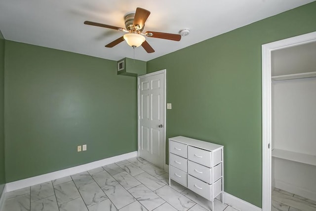 unfurnished bedroom with marble finish floor, baseboards, visible vents, and a ceiling fan