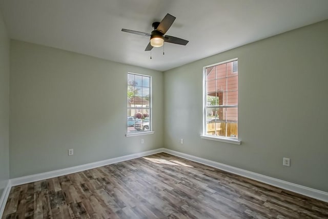 unfurnished room with baseboards, ceiling fan, and wood finished floors
