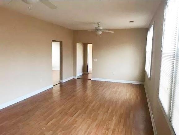 313840 Louisiana Ave Parkway, New Orleans, LA 70125 - spare room featuring ceiling fan, wood finished floors, and baseboards