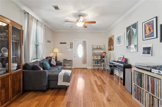 4718 Annette St, New Orleans, LA 70122 - living area with light wood finished floors, visible vents, crown molding, and a ceiling fan