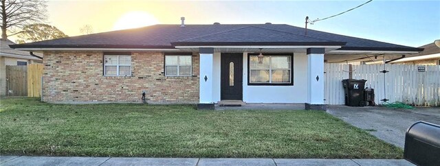 2713 Volpe Dr, Chalmette, LA 70043 - view of front facade featuring roof with shingles, brick siding, fence, and a front lawn