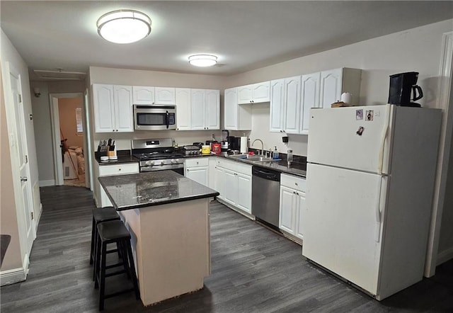 2713 Volpe Dr, Chalmette, LA 70043 - kitchen featuring white cabinets, a sink, dark wood-style flooring, and appliances with stainless steel finishes