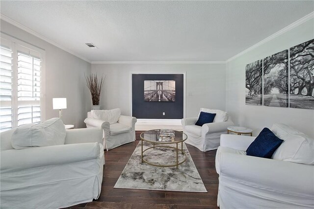 living area with visible vents, ornamental molding, wood finished floors, and a textured ceiling