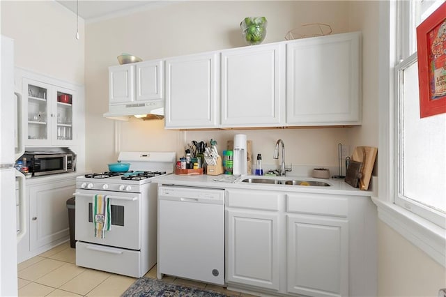 710 Burdette St, New Orleans, LA 70118 - kitchen with white cabinetry, light countertops, white appliances, under cabinet range hood, and a sink