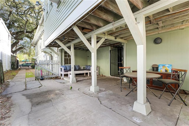 710 Burdette St, New Orleans, LA 70118 - view of patio featuring an outdoor living space, outdoor dining area, and fence