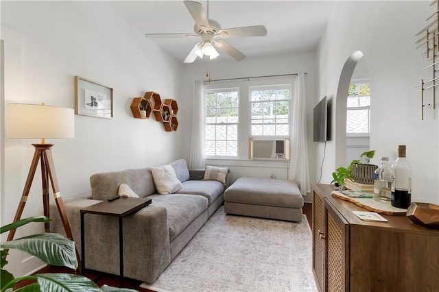 710 Burdette St, New Orleans, LA 70118 - living area with cooling unit, a ceiling fan, and arched walkways