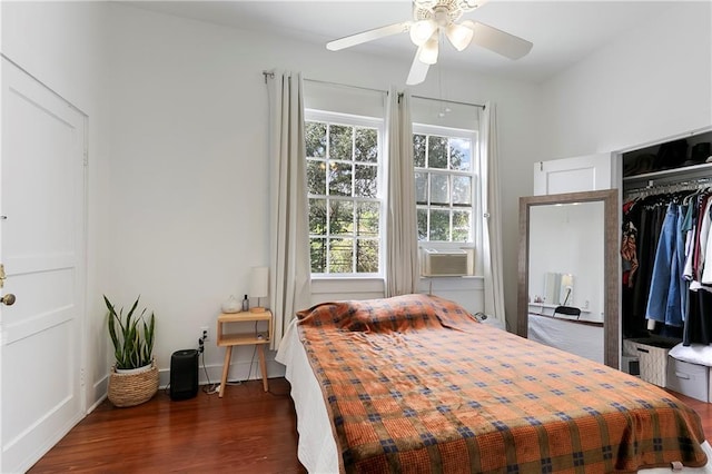 710 Burdette St, New Orleans, LA 70118 - bedroom featuring cooling unit, baseboards, dark wood finished floors, a ceiling fan, and a closet