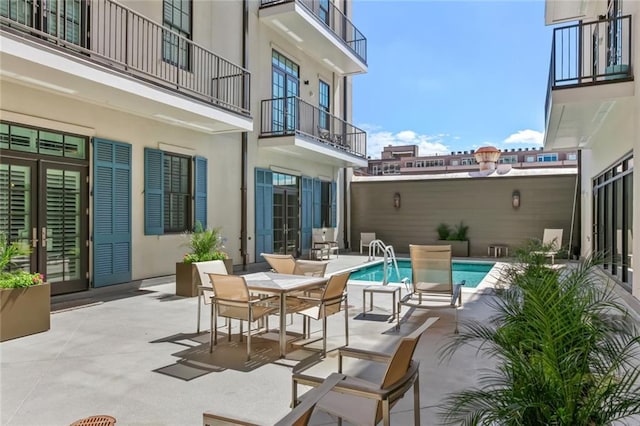 731 St Charles Ave Unit 402, New Orleans, LA 70130 - view of patio with an outdoor pool and a balcony