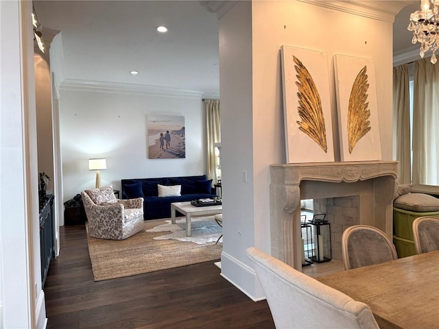 interior space featuring dark wood-type flooring, a fireplace, a notable chandelier, and ornamental molding