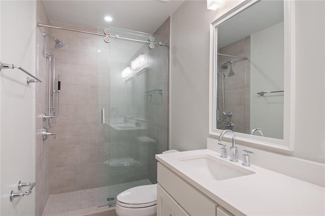 bathroom with toilet, recessed lighting, a shower stall, and vanity