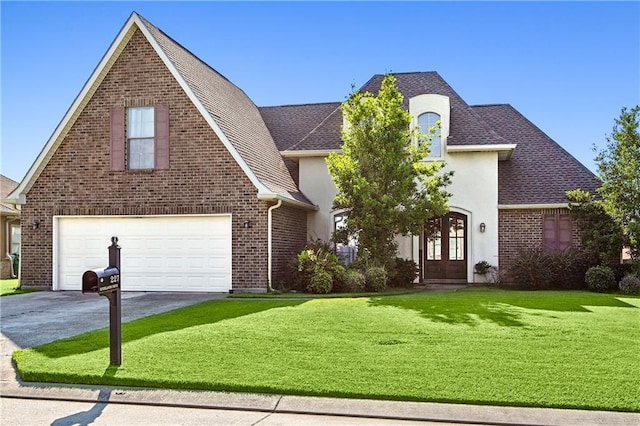 227 Riverlands Dr, La Place, LA 70068 - view of front facade with french doors, driveway, a front yard, an attached garage, and a shingled roof