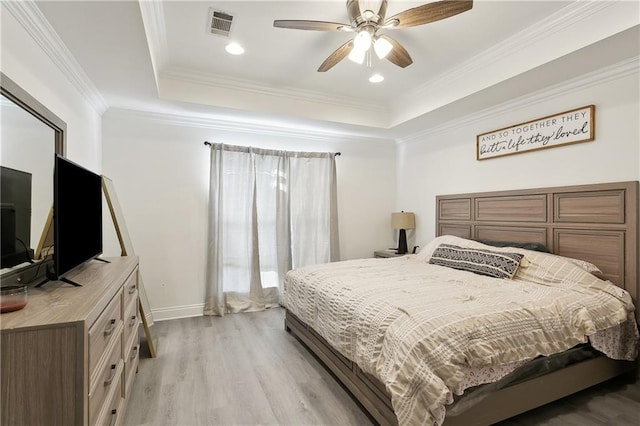 227 Riverlands Dr, La Place, LA 70068 - bedroom with light wood finished floors, a tray ceiling, ornamental molding, ceiling fan, and recessed lighting