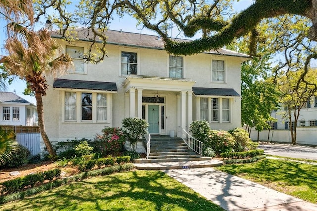 119 Audubon Blvd, New Orleans, LA 70118 - view of front of house with stucco siding and a front lawn