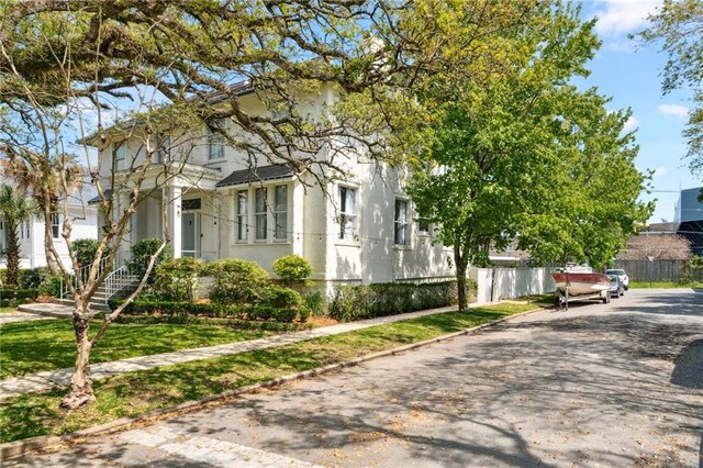 119 Audubon Blvd, New Orleans, LA 70118 - view of front of property featuring stucco siding and driveway