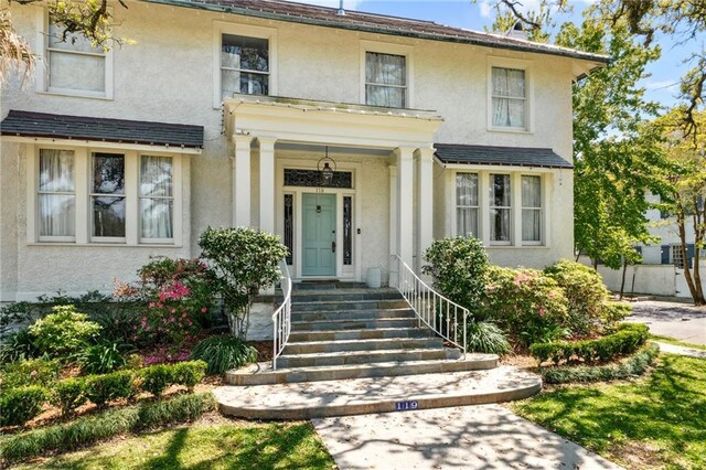 119 Audubon Blvd, New Orleans, LA 70118 - view of front of home featuring stucco siding and covered porch