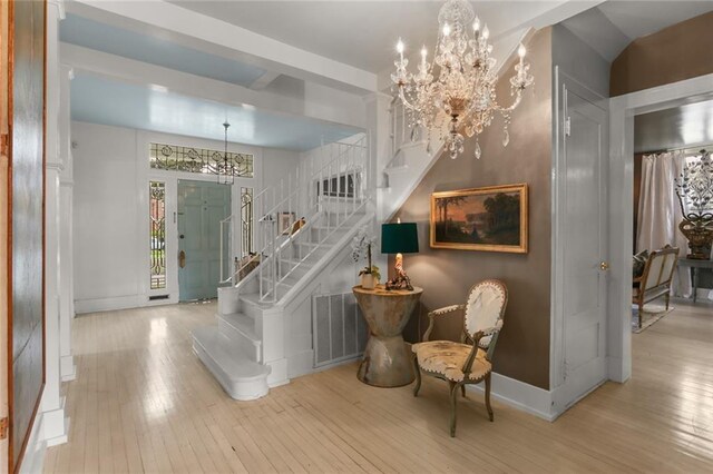 119 Audubon Blvd, New Orleans, LA 70118 - entrance foyer with a chandelier, stairs, hardwood / wood-style flooring, and baseboards