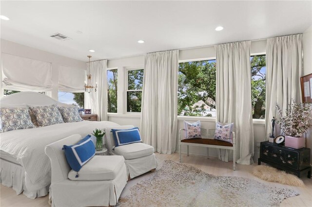 119 Audubon Blvd, New Orleans, LA 70118 - bedroom featuring multiple windows, wood finished floors, and recessed lighting