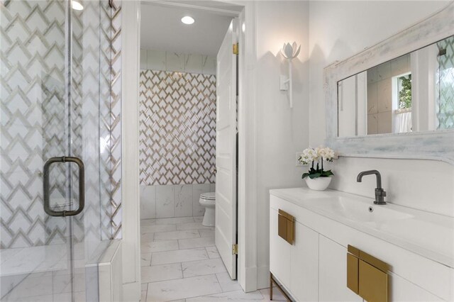 119 Audubon Blvd, New Orleans, LA 70118 - full bathroom featuring marble look tiles, vanity, toilet, a shower, and recessed lighting