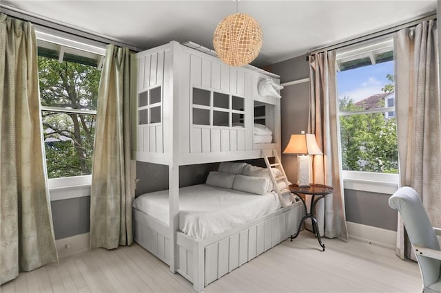 119 Audubon Blvd, New Orleans, LA 70118 - bedroom featuring baseboards, wood finished floors, and multiple windows