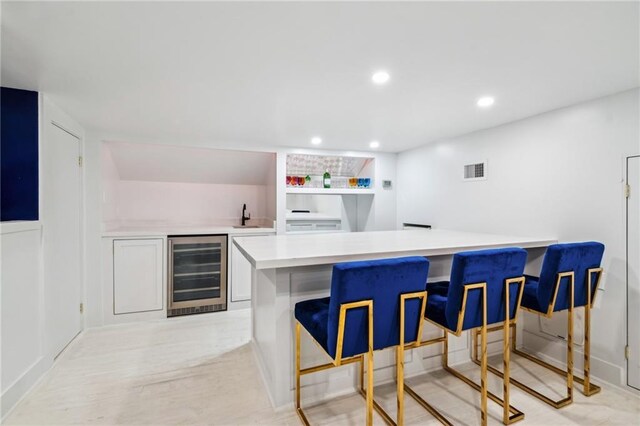 119 Audubon Blvd, New Orleans, LA 70118 - indoor wet bar featuring wine cooler, light wood-style floors, and recessed lighting