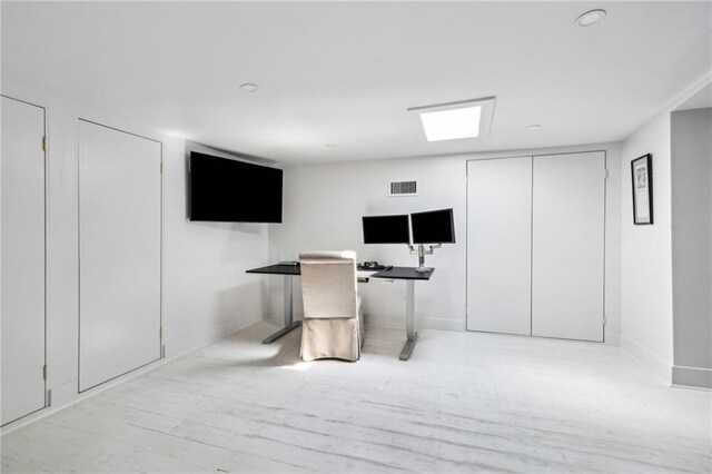 119 Audubon Blvd, New Orleans, LA 70118 - below grade area with an office area, wood finished floors, and baseboards