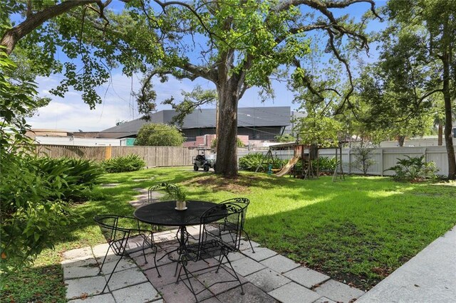 119 Audubon Blvd, New Orleans, LA 70118 - view of yard featuring a patio area, a playground, and outdoor dining area