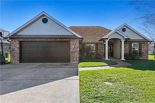 313 Oak Point Dr, La Place, LA 70068 - view of front facade featuring concrete driveway, a front yard, brick siding, and an attached garage