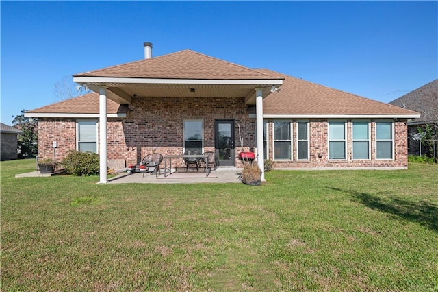 313 Oak Point Dr, La Place, LA 70068 - rear view of house featuring brick siding, a yard, a patio area, and roof with shingles