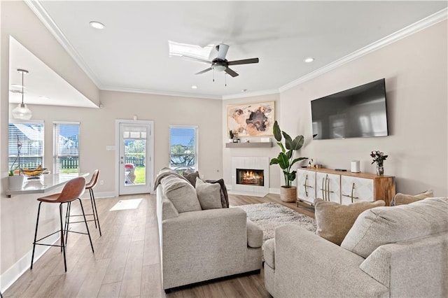 313 Oak Point Dr, La Place, LA 70068 - living area with ceiling fan, a tile fireplace, recessed lighting, baseboards, and light wood finished floors