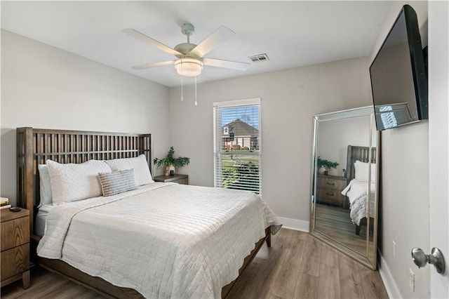 313 Oak Point Dr, La Place, LA 70068 - bedroom with wood finished floors, baseboards, and ceiling fan