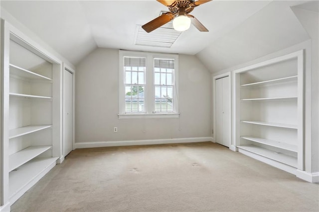 bonus room featuring vaulted ceiling, carpet floors, and built in features