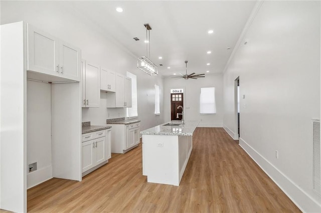 2460 N Villere St, New Orleans, LA 70117 - kitchen with a sink, ceiling fan, white cabinetry, a center island with sink, and recessed lighting