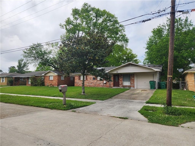 single story home with a front lawn, an attached garage, brick siding, and concrete driveway
