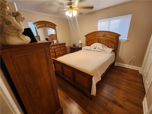 bedroom featuring dark wood-style flooring, baseboards, multiple windows, and ceiling fan