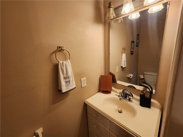 half bathroom featuring toilet and vanity