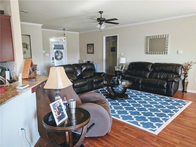 living area featuring crown molding, ceiling fan, wood finished floors, and baseboards