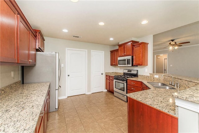 524 Jessica Way, Covington, LA 70435 - kitchen with a sink, stainless steel appliances, a ceiling fan, light stone countertops, and recessed lighting