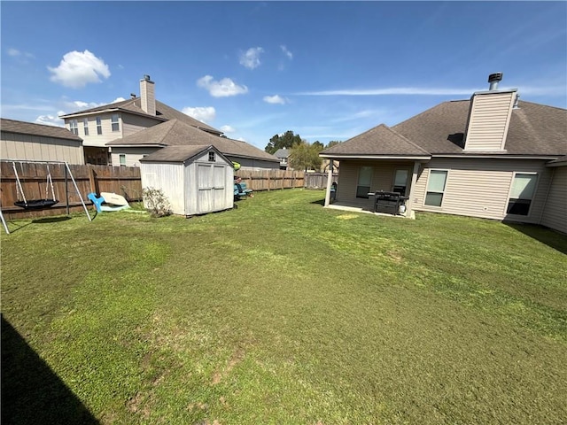 view of yard featuring a patio, a shed, a fenced backyard, and an outdoor structure