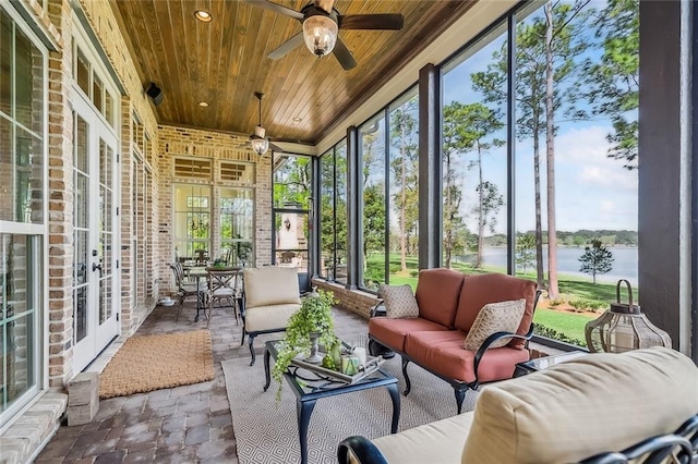 sunroom with an outdoor hangout area, a water view, ceiling fan, and french doors
