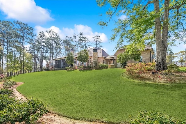 view of yard featuring a sunroom