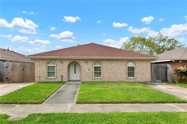 3416 Dauterive Dr, Chalmette, LA 70043 - view of front of house featuring a gate, a front lawn, brick siding, fence, and a shingled roof