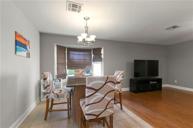 3416 Dauterive Dr, Chalmette, LA 70043 - dining area featuring visible vents, baseboards, a notable chandelier, and light tile patterned floors