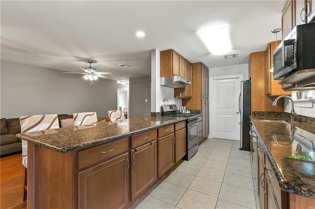 3416 Dauterive Dr, Chalmette, LA 70043 - kitchen with a kitchen bar, visible vents, appliances with stainless steel finishes, under cabinet range hood, and a sink