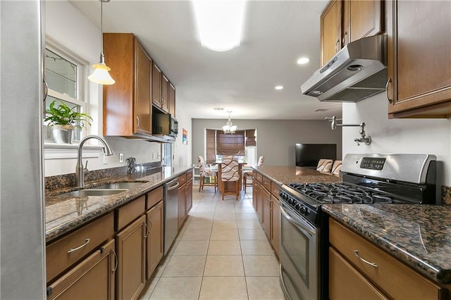 3416 Dauterive Dr, Chalmette, LA 70043 - kitchen with an inviting chandelier, under cabinet range hood, a sink, stainless steel appliances, and brown cabinets