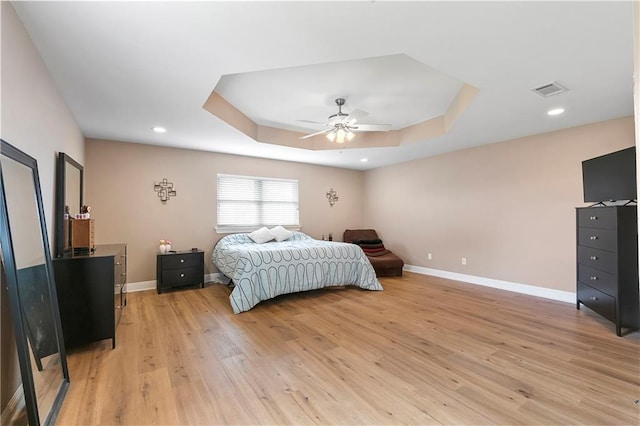 3416 Dauterive Dr, Chalmette, LA 70043 - bedroom with light wood-type flooring, baseboards, a ceiling fan, visible vents, and a tray ceiling
